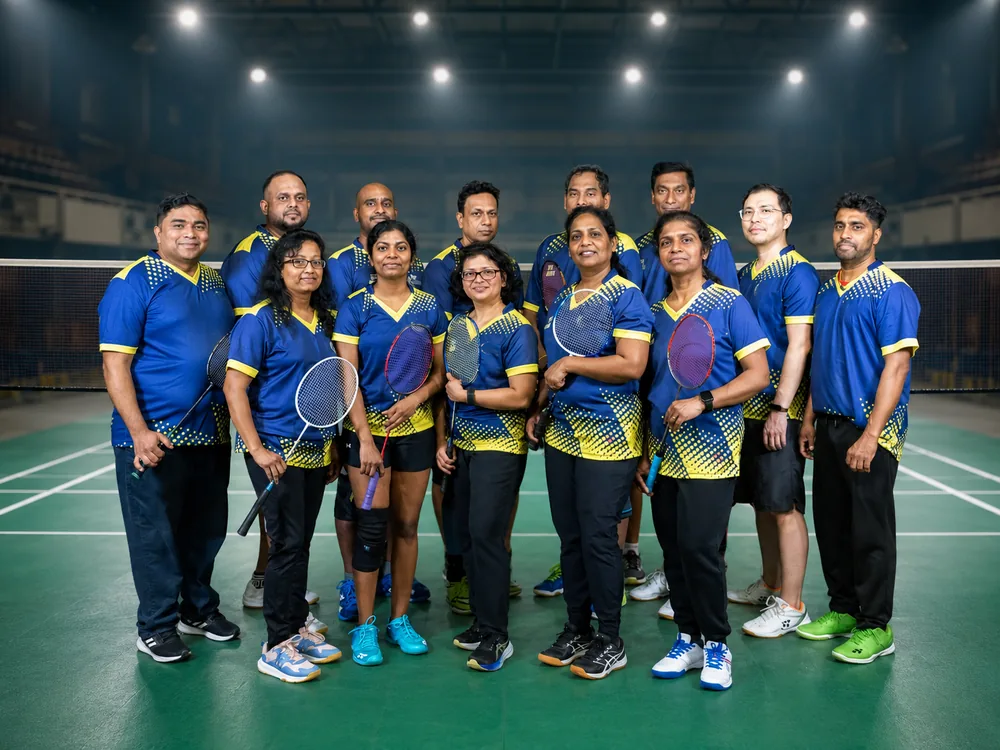 Toronto Smashers team in blue and yellow jerseys posing on court at the Adult Team Tournament