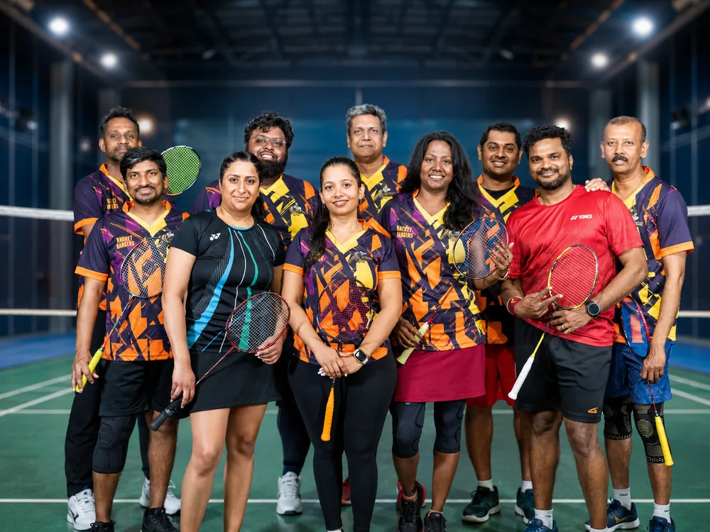 Racket Rangers team in orange and purple jerseys on court