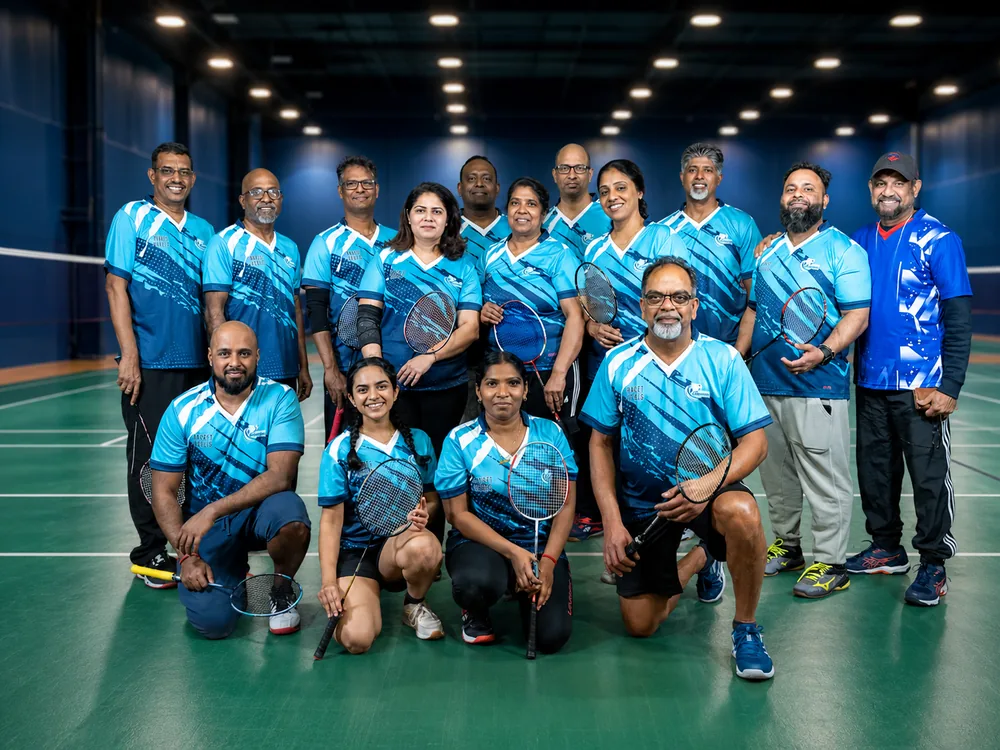Racket Rangers team in blue jerseys gathered on court