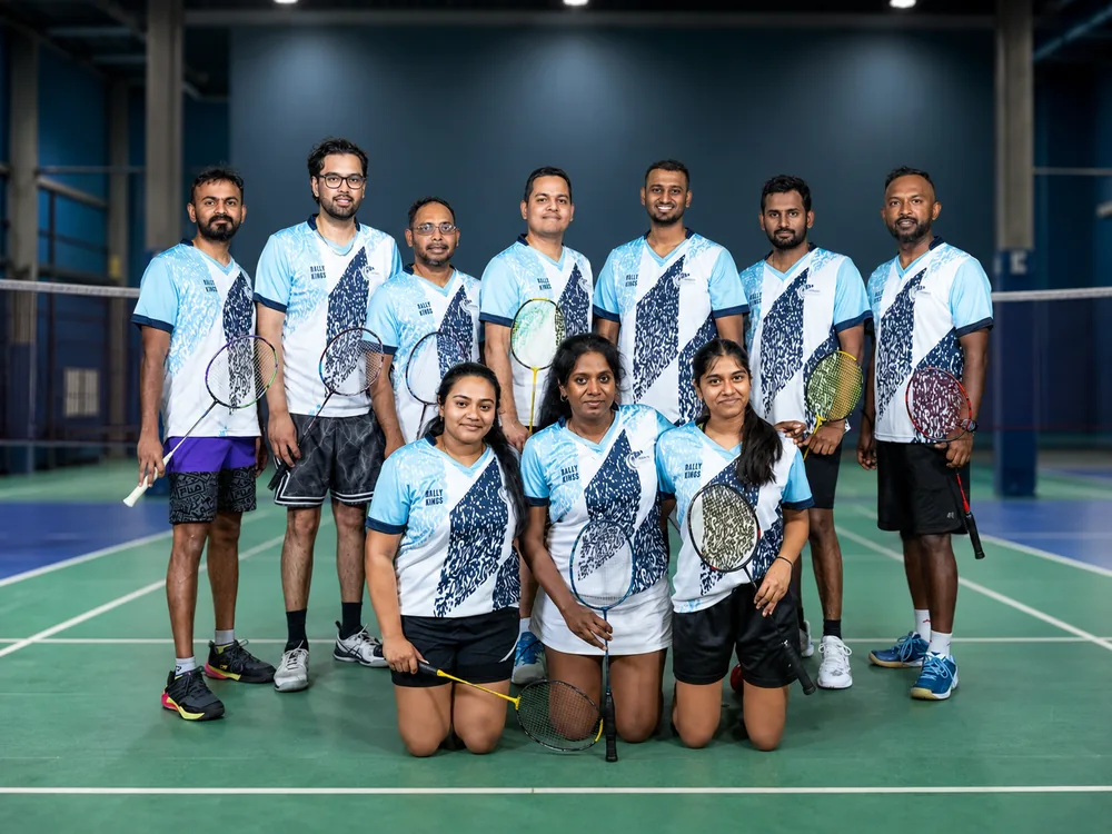 Rally Kings team in light blue jerseys posing on court