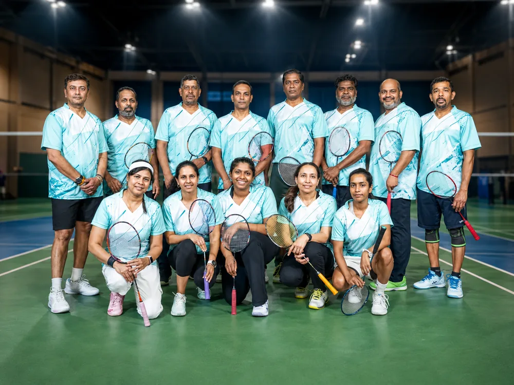 Toronto Smashers team in teal jerseys lined up on court with rackets